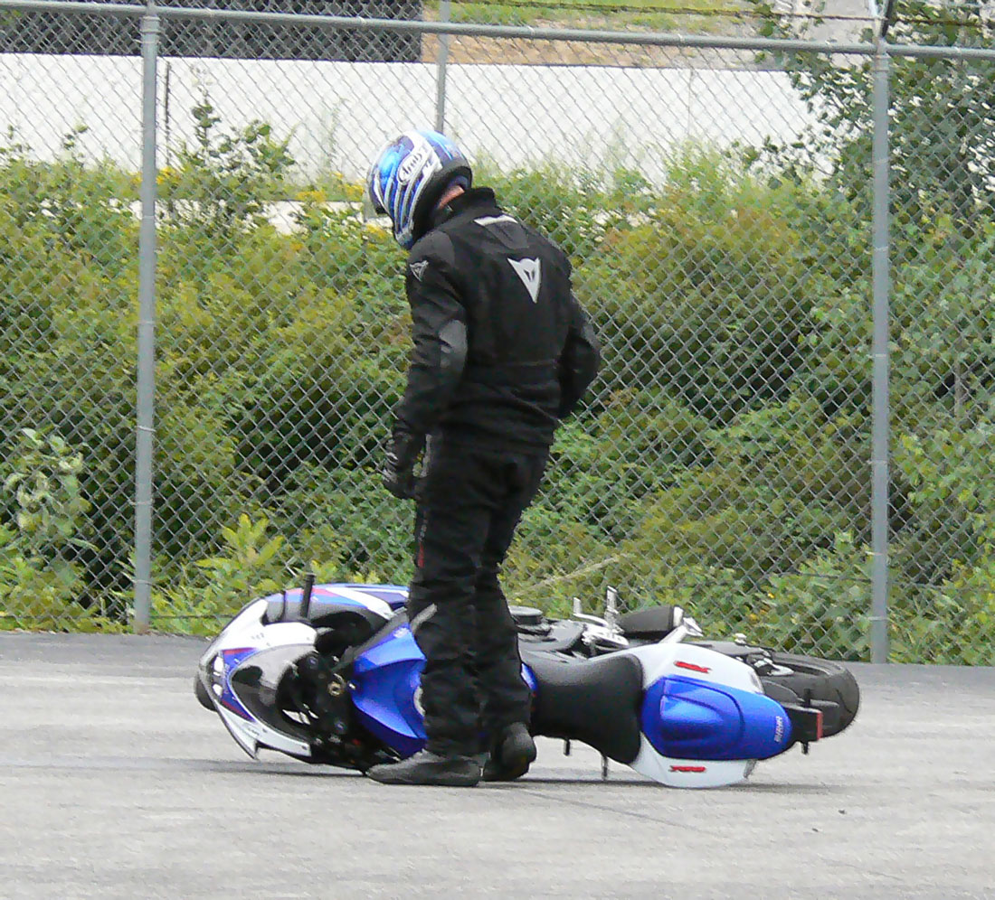 Motorcycle guy with bike dropped